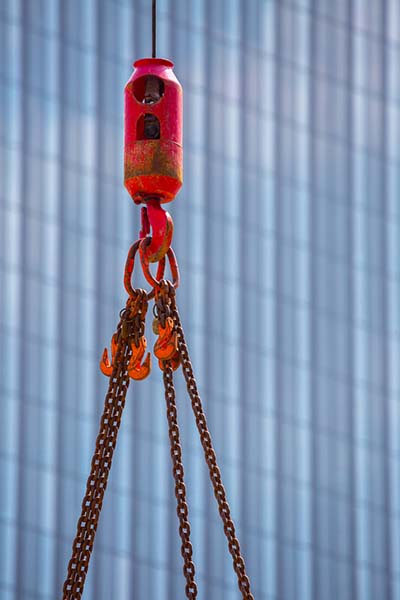 large crane hoisting in a city neighborhood